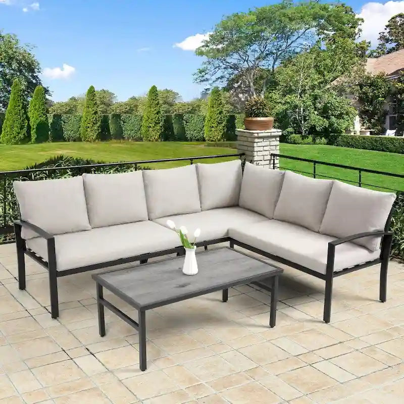 Ensemble de mobilier de patio en acier 4 pièces avec coussins beiges et table basse